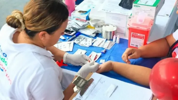 Healthcare professional conducting blood tests at a community health fair.