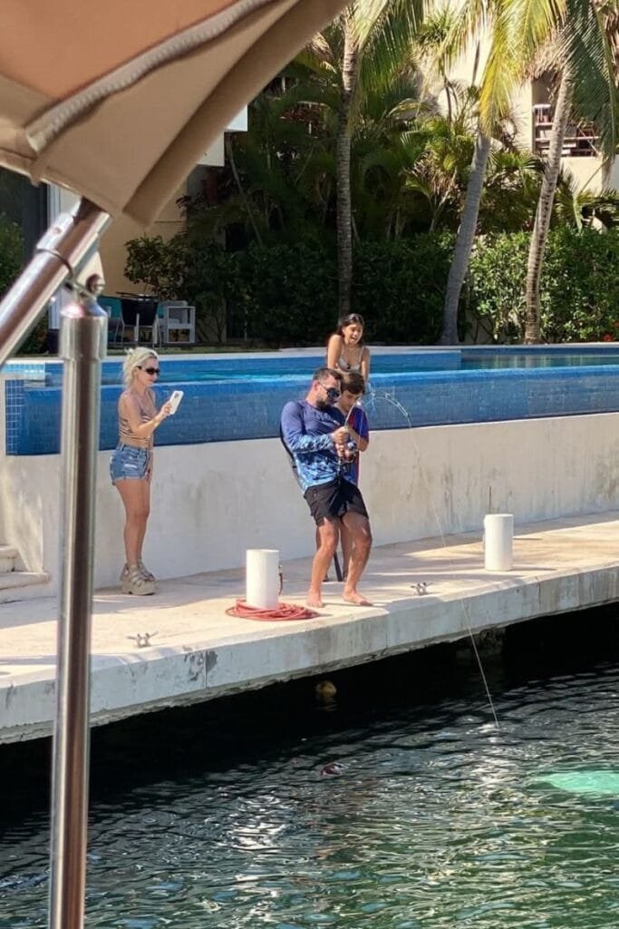 tourist illegally catching an eagle ray in puerto aventuras