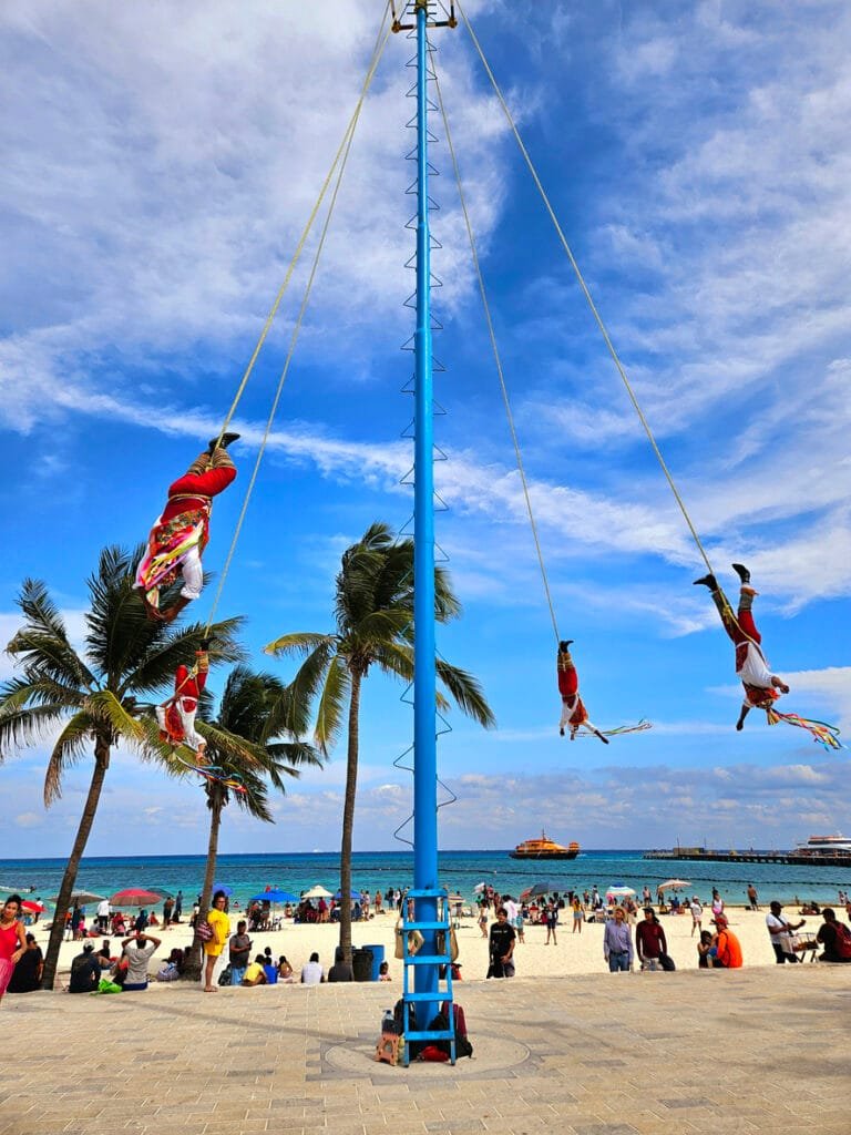 Mexican Papantla Flyers, or Dance of the Flyers at the Founders Park in Playa de Carmen. Flyers hang from a rope attached to a pole.
