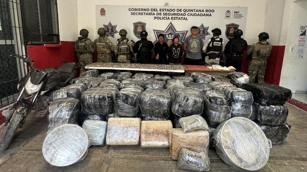 Law enforcement officials with seized drugs and motorcycle in Quintana Roo, Mexico
