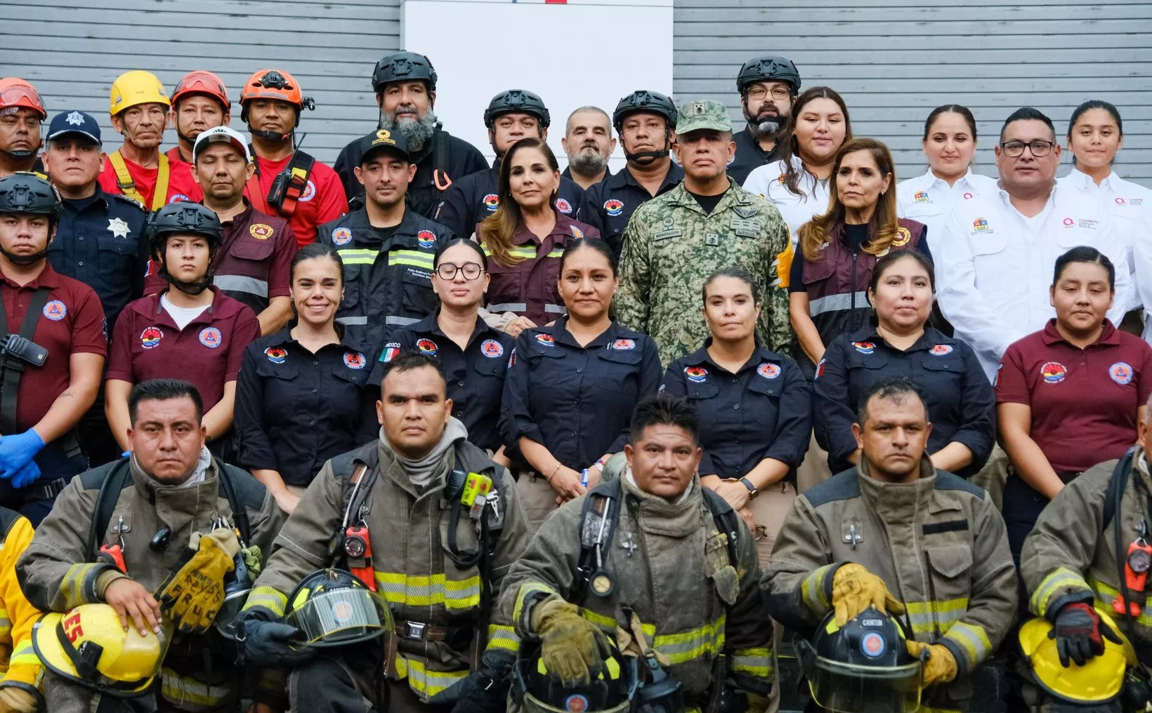 A group photo of emergency responders, including firefighters, police, and other support personnel, posing together in uniform.$