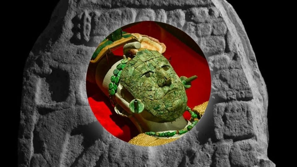a close-up of a jade face mask displayed on a red background surrounded by a carved stone structure