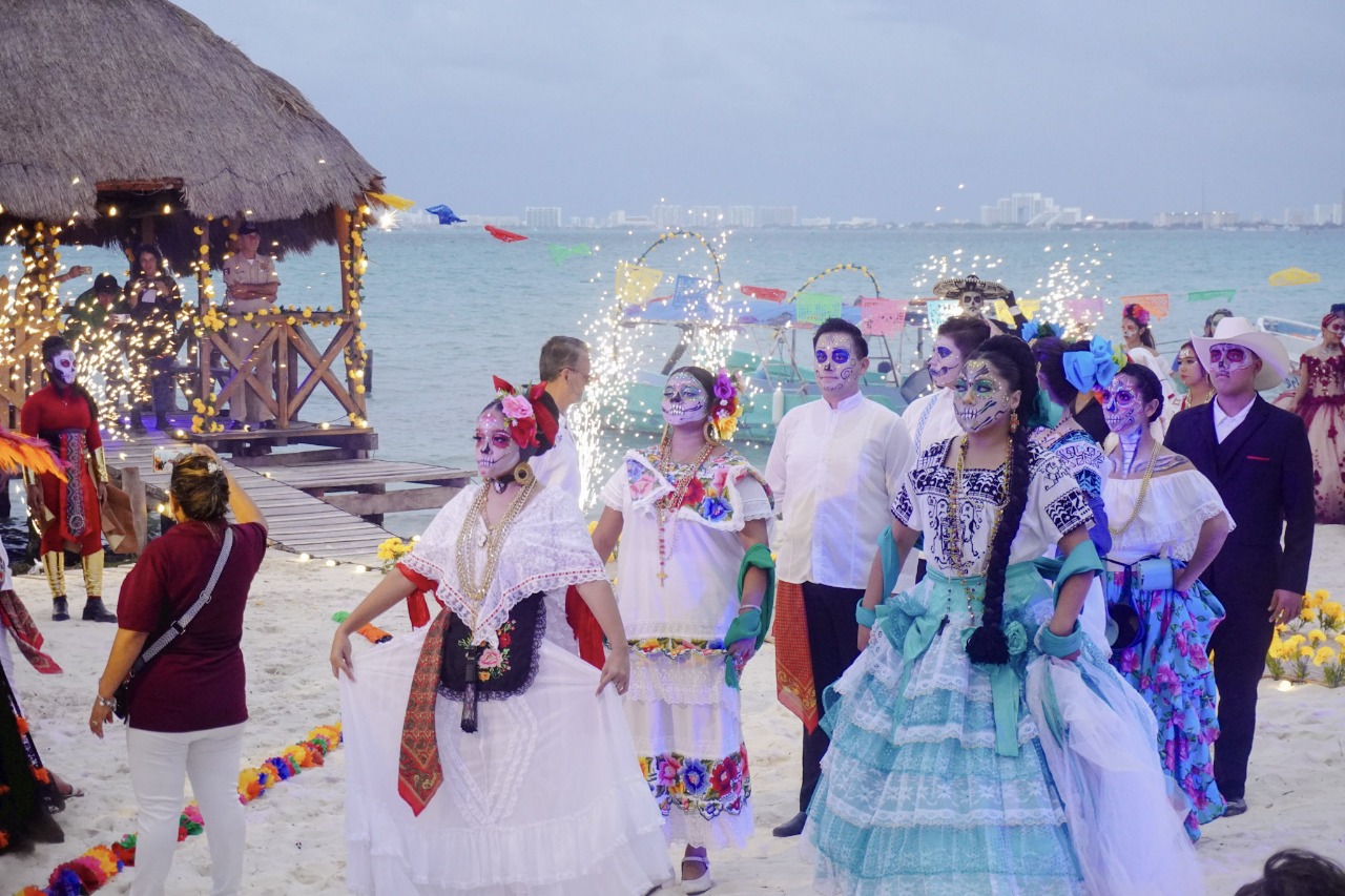 a group of people in traditional attire with painted faces participating in a beach festivity-20102025