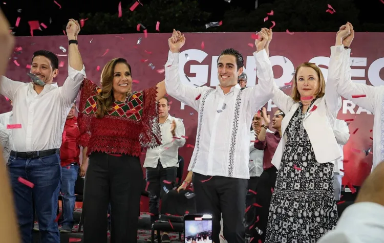 A group of political candidates holding hands while celebrating at a rally with confetti in the air.$# CAPTION
