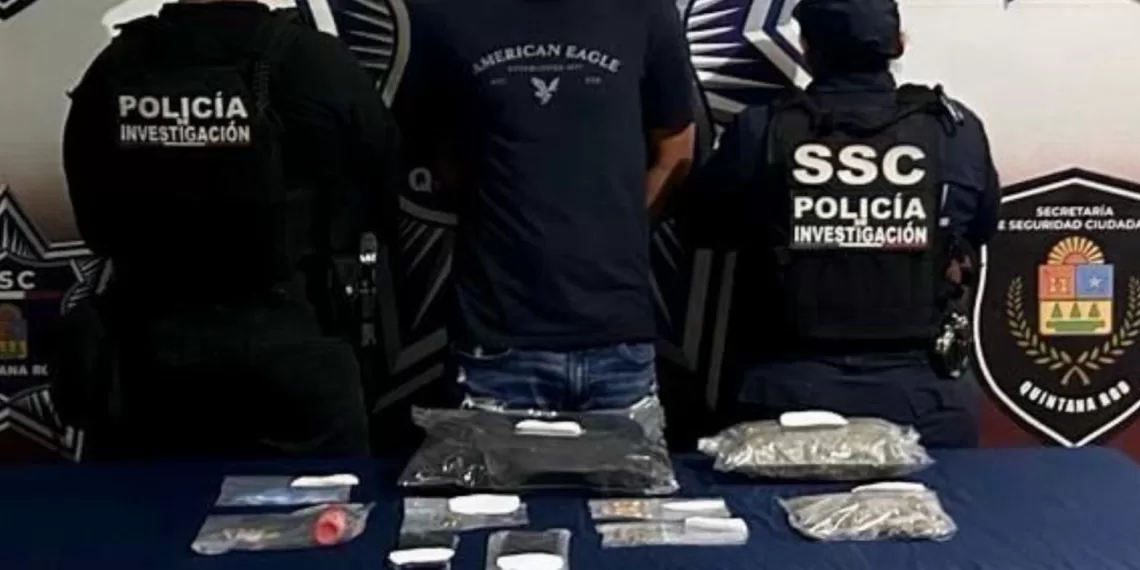 A law enforcement operation showcasing a suspect and seized drugs on a table in Quintana Roo, Mexico.$# CAPTION