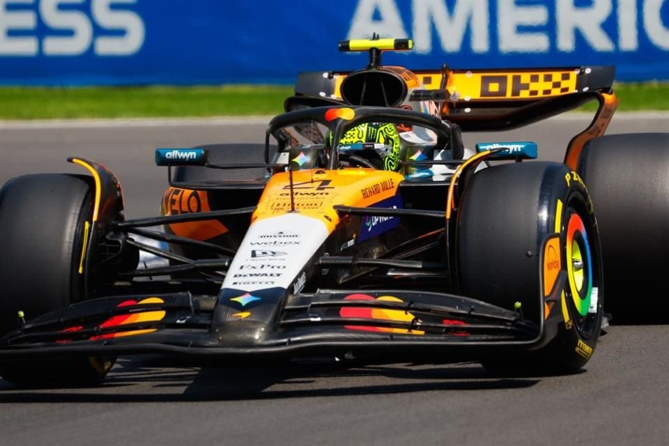 A brightly colored Formula 1 race car speeding on the racetrack with sponsor logos visible on the vehicle.$# CAPTION