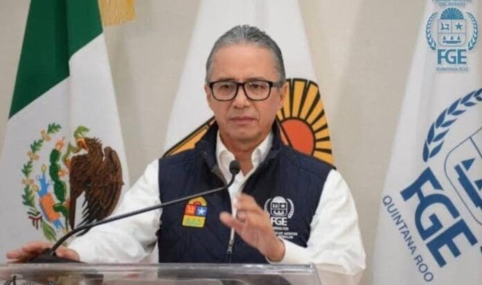 A man speaking at a podium during a press conference, with flags and a logo in the background.$#$ CAPTION