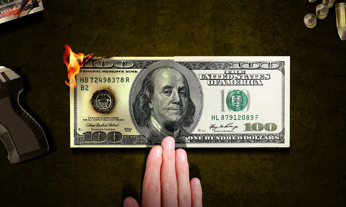 A hundred-dollar bill partially on fire, with a hand reaching towards it, set against a dark background with a handgun and bullets nearby.$# CAPTION