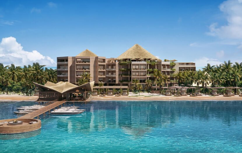 modern beachfront resort surrounded by palm trees and clear water