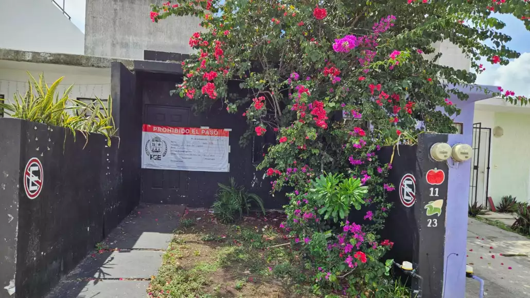 entrance to a property with colorful flowers and a warning sign stating prohibited access