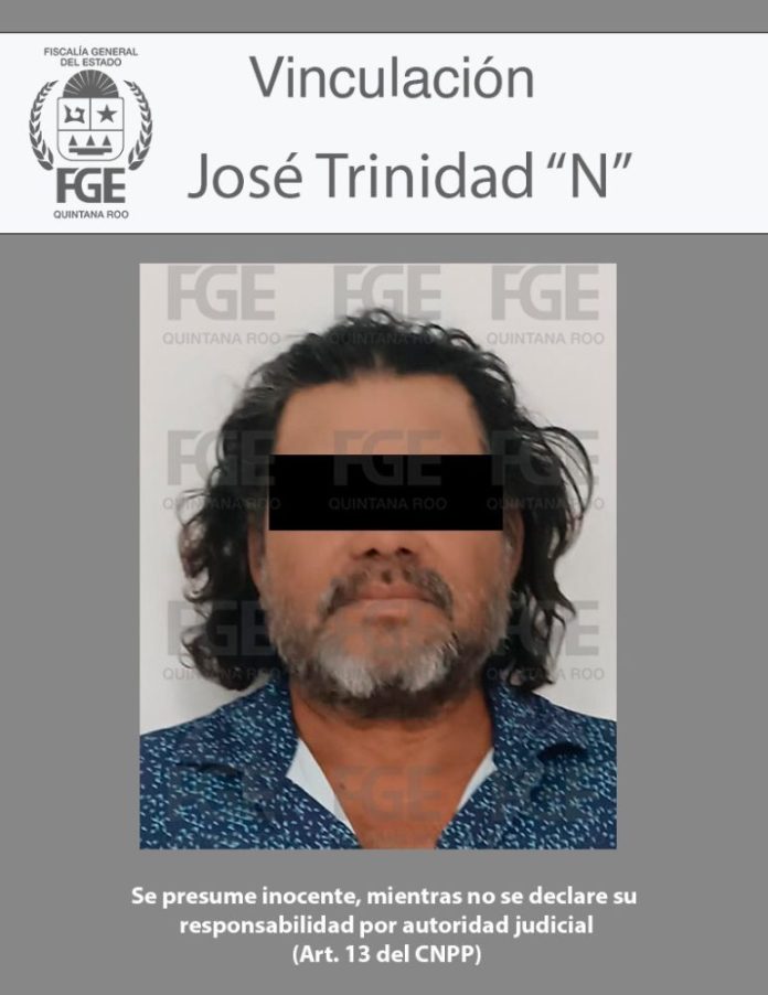 A police identification photo of a man with long hair and a beard, wearing a patterned shirt. The image includes text indicating he is linked to a legal case in Quintana Roo. His face has been obscured for privacy.
