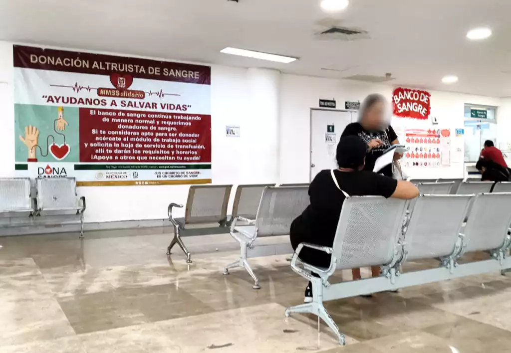 interior of a blood donation center with a promotional banner and people waiting-27112025