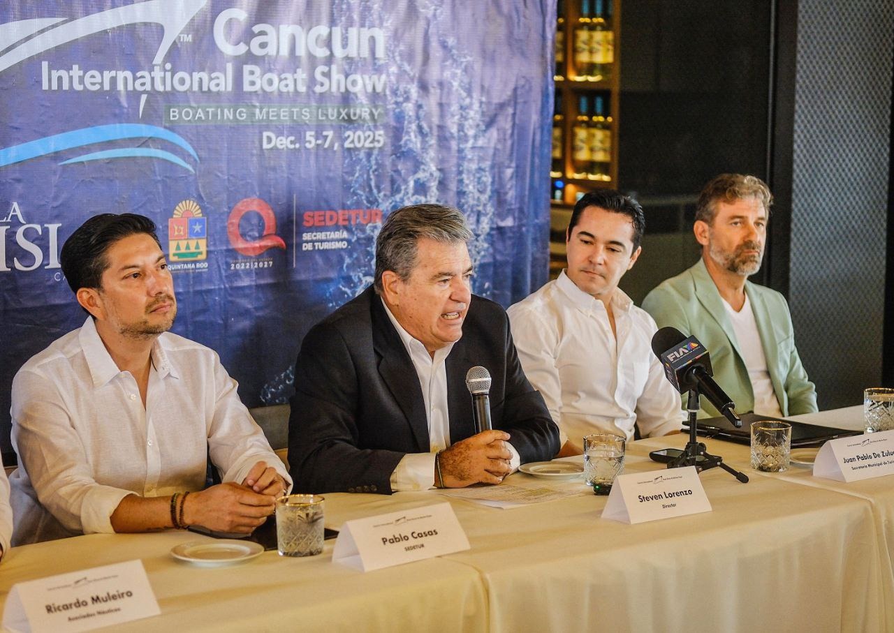 A press conference for the Cancun International Boat Show featuring four speakers at a table with a backdrop of the event's logo, discussing plans for December 2025.