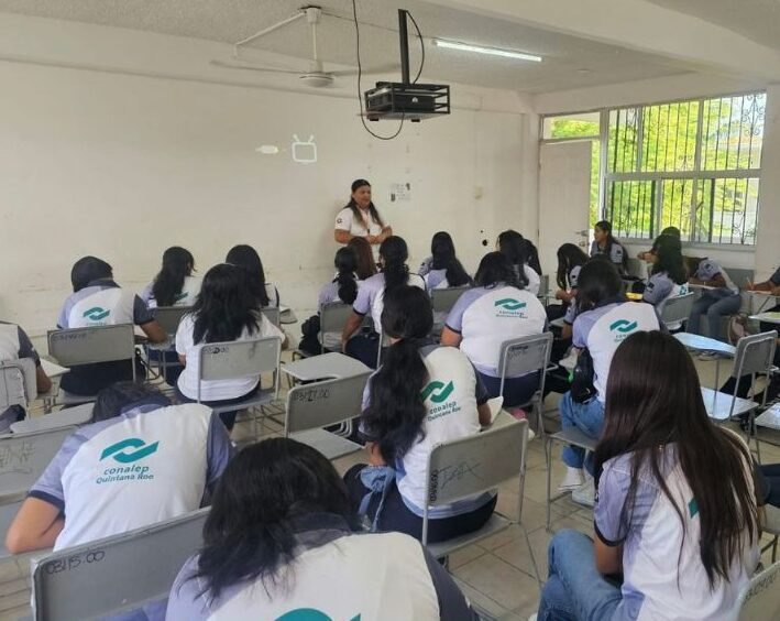 a teacher instructs students in a classroom filled with desks and chairs