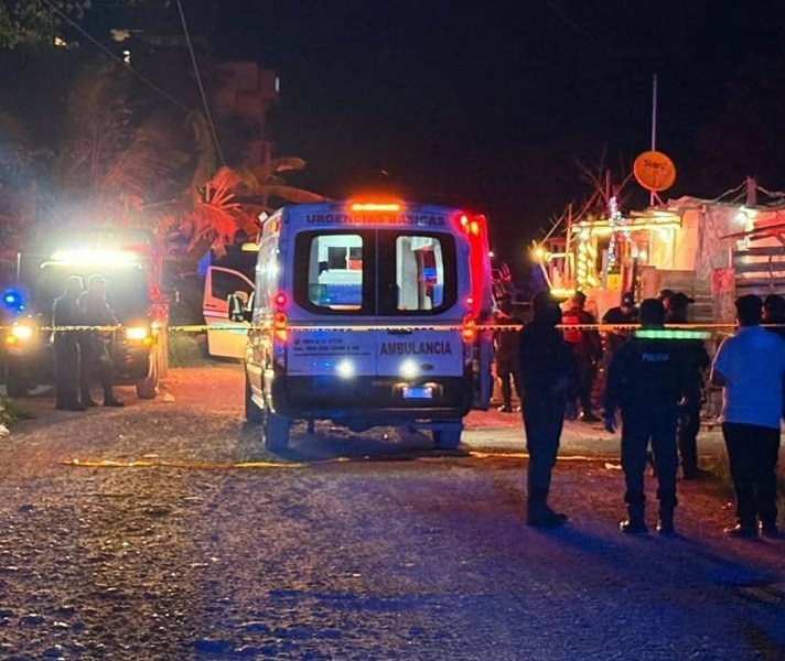 Emergency vehicles and police officers at a night scene with flashing lights and caution tape.$#$ CAPTION