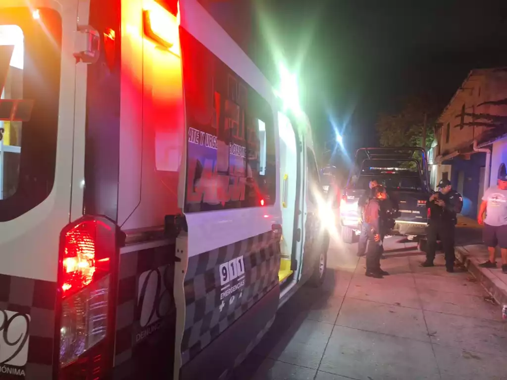 emergency services response scene with police and ambulance at night
