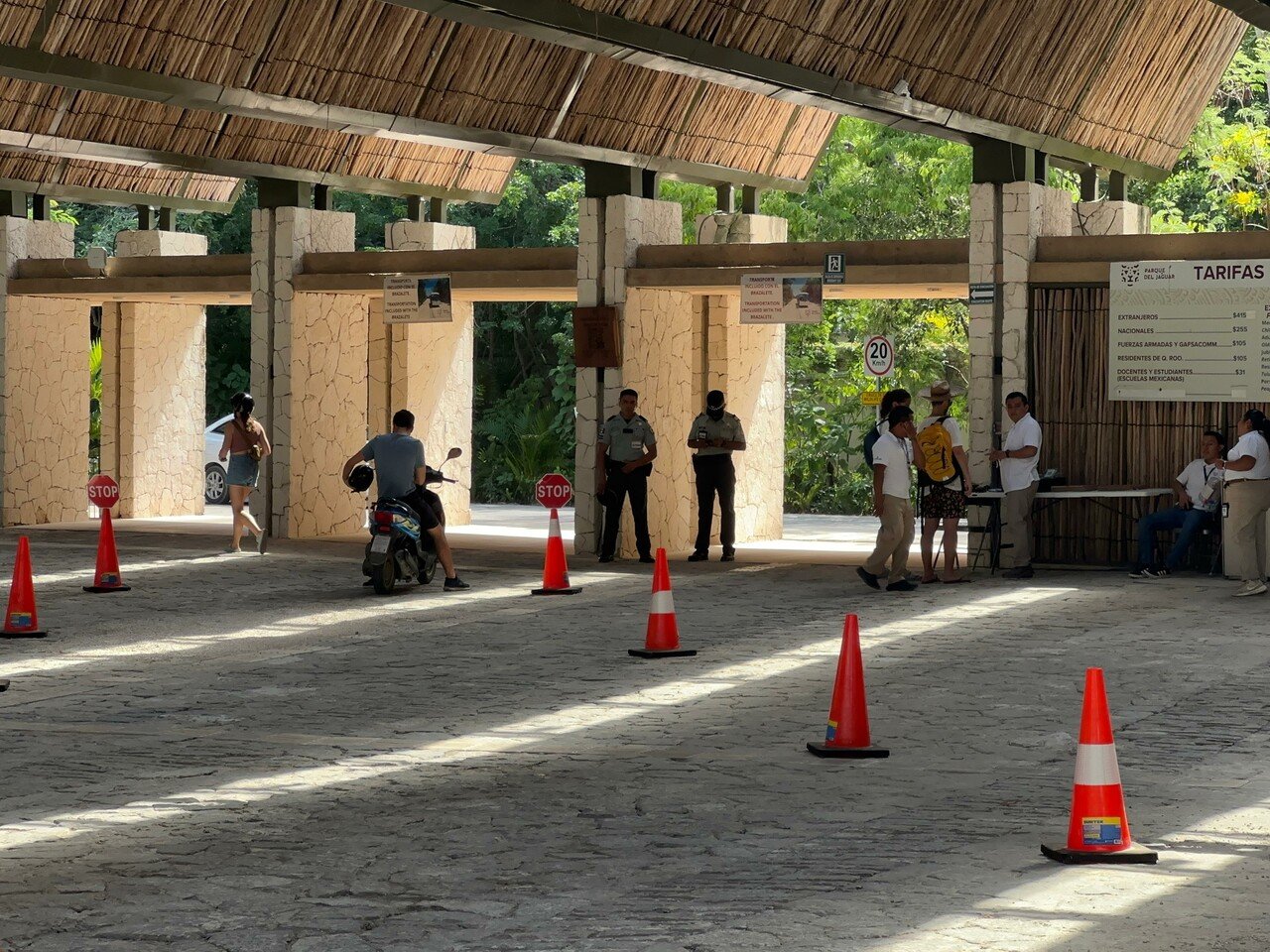 a view of the entrance with traffic cones and people interacting-09112025