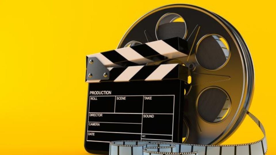 a film reel with a clapperboard and film strip on a bright yellow background