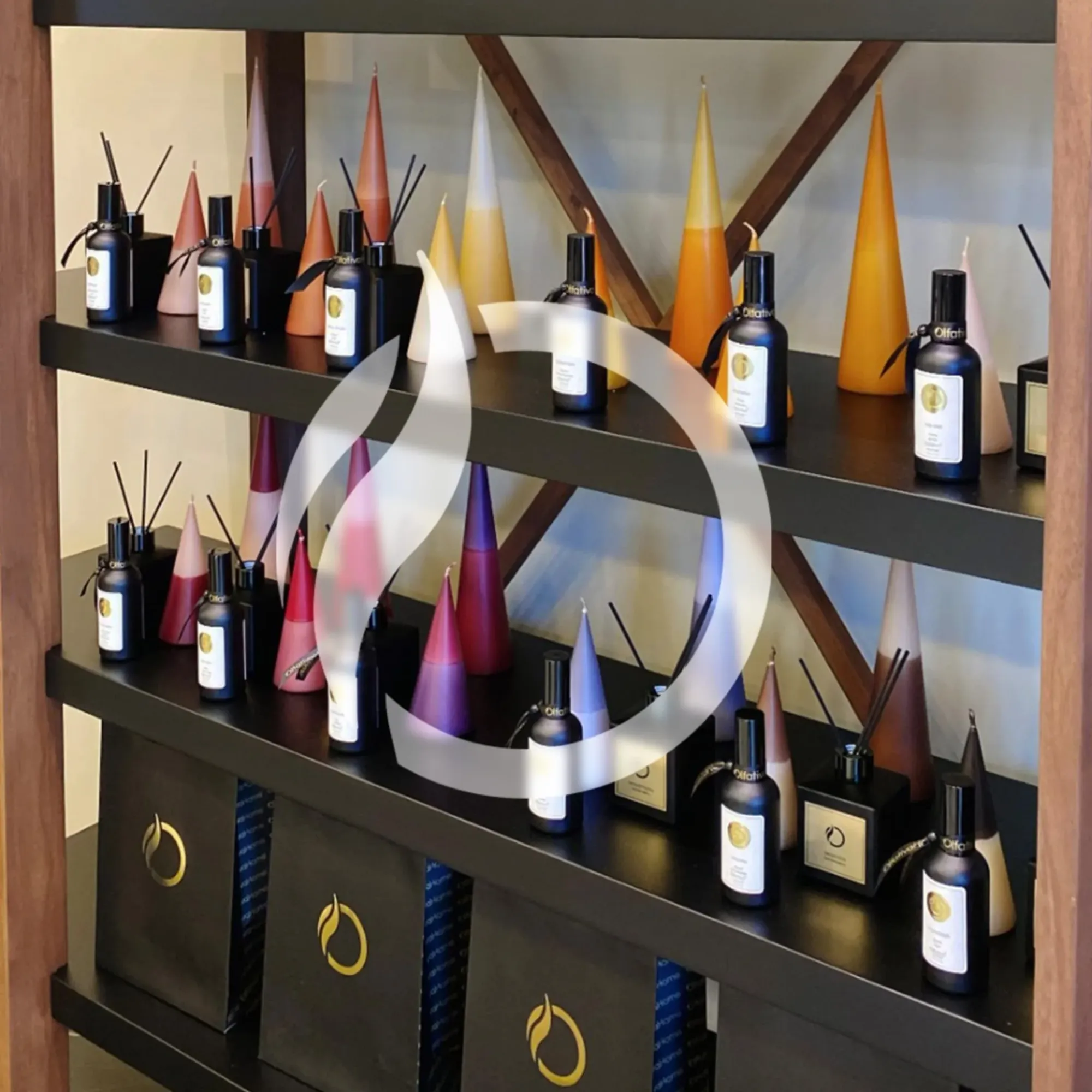 A stylish display of various fragrance bottles and colorful cone-shaped decorations on shelves in a modern interior design.$#$ CAPTION