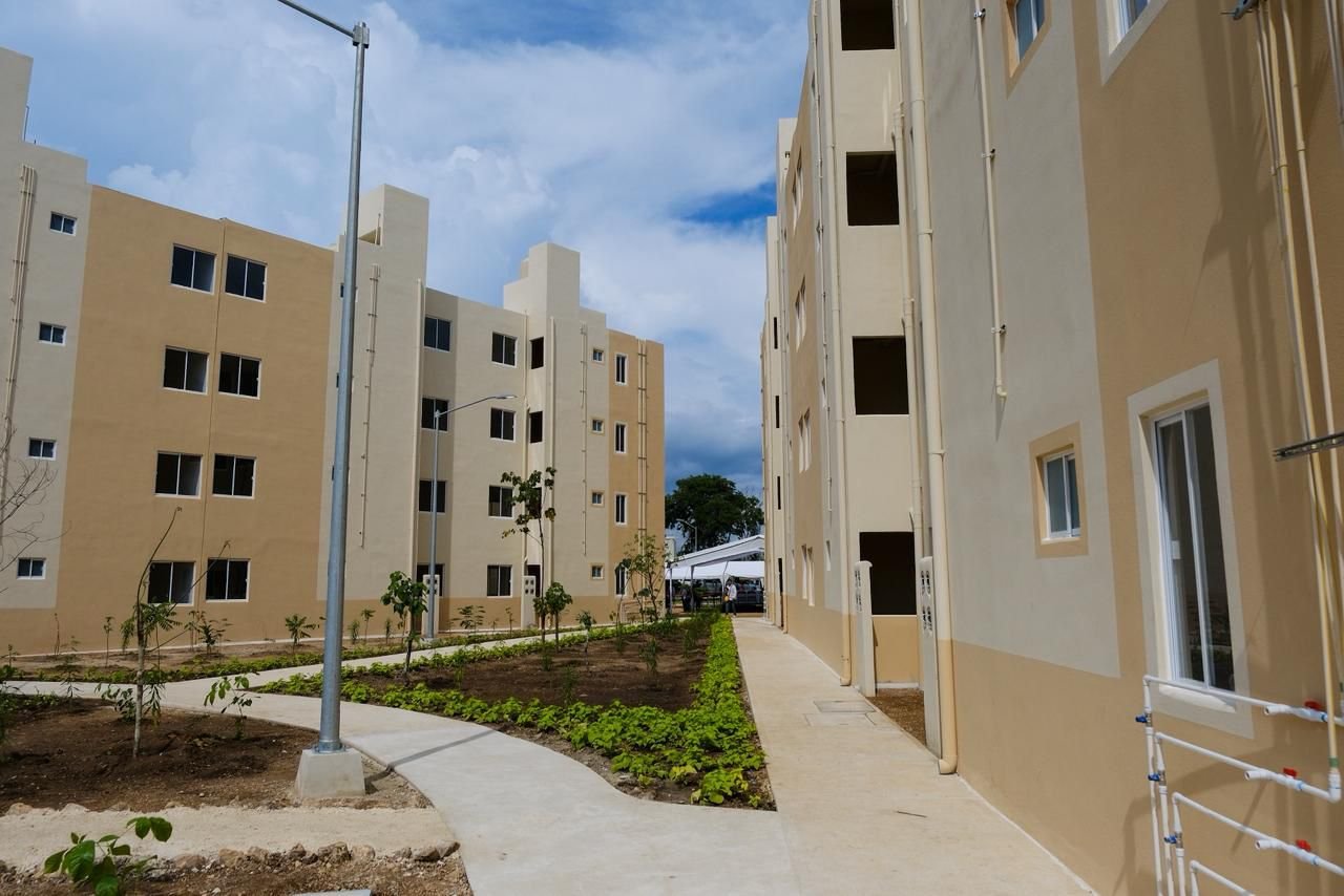 view of a new residential building complex with pathways and landscaped areas