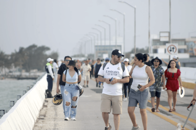 People walking on the Progreso pier during the Christmas sea walk event