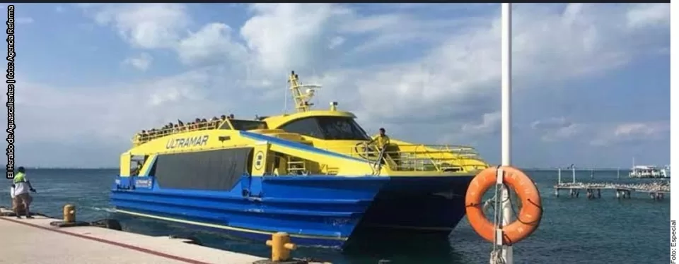 A yellow and blue Ultramar ferry is docked, with people visible on the upper deck and a lifebuoy in the foreground