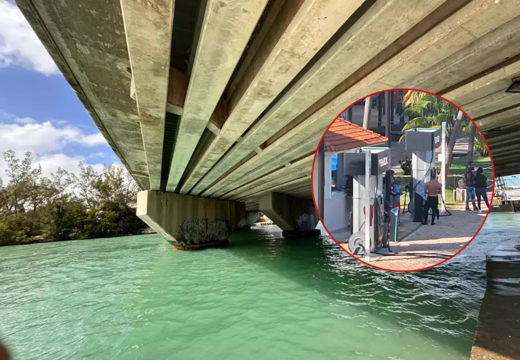 under a concrete bridge with a gas station visible nearby-24112025