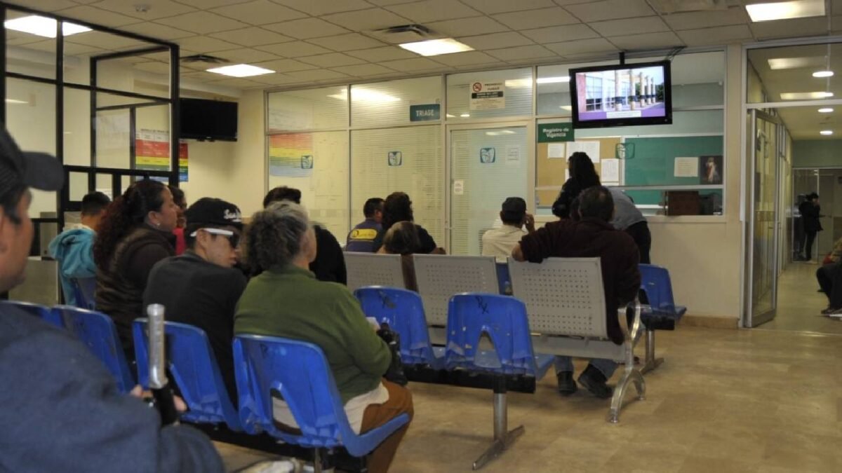 people sitting in a waiting area looking at a television screen in a medical facility