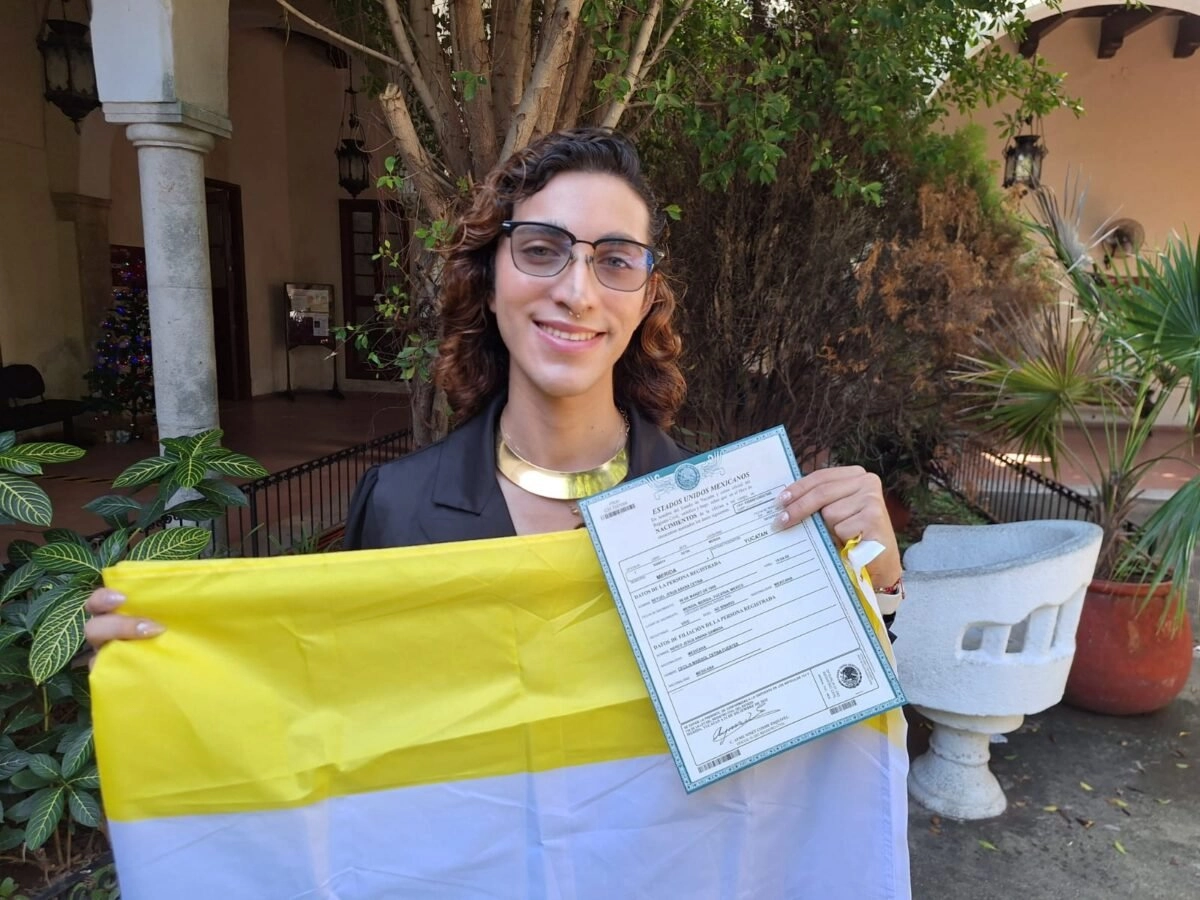 Betuel Cetina holding the first non-binary birth certificate issued in Yucatán