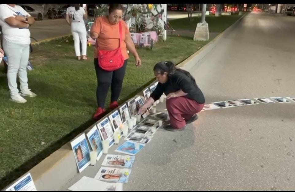 Members of the Truth Memory and Justice collective holding a candlelight vigil