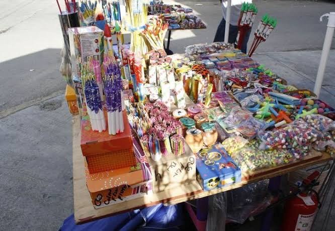 A tianguis market scene showing fireworks for sale during the holiday season