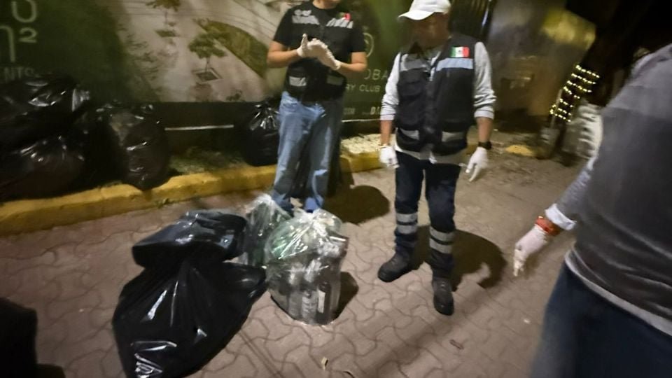 Cleaning personnel removing glass bottles from Fifth Avenue in Playa del Carmen