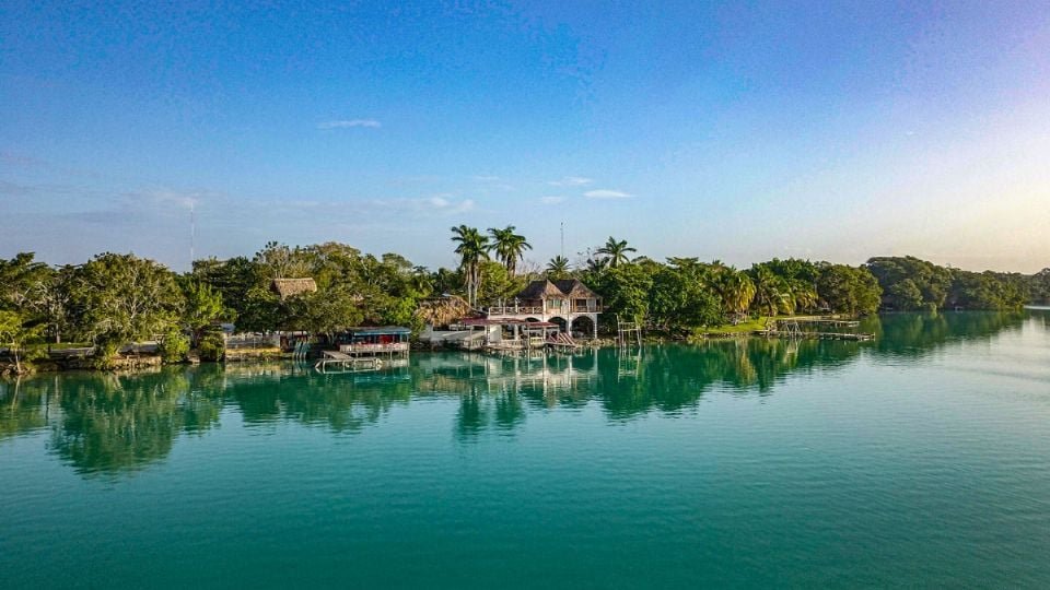 Aerial view of the turquoise Laguna Milagros in Huay Pix surrounded by low jungle
