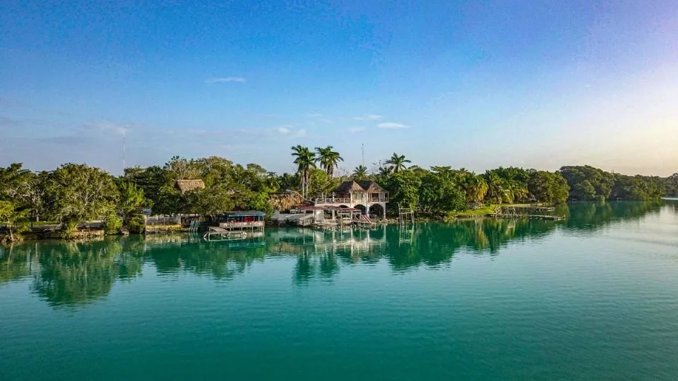 Aerial view of the turquoise Laguna Milagros in Huay Pix surrounded by low jungle