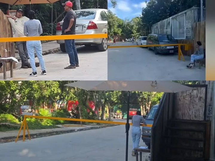 A barrier installed on a public road in Aldea Zama, Tulum, where unauthorized parking fees are being charged