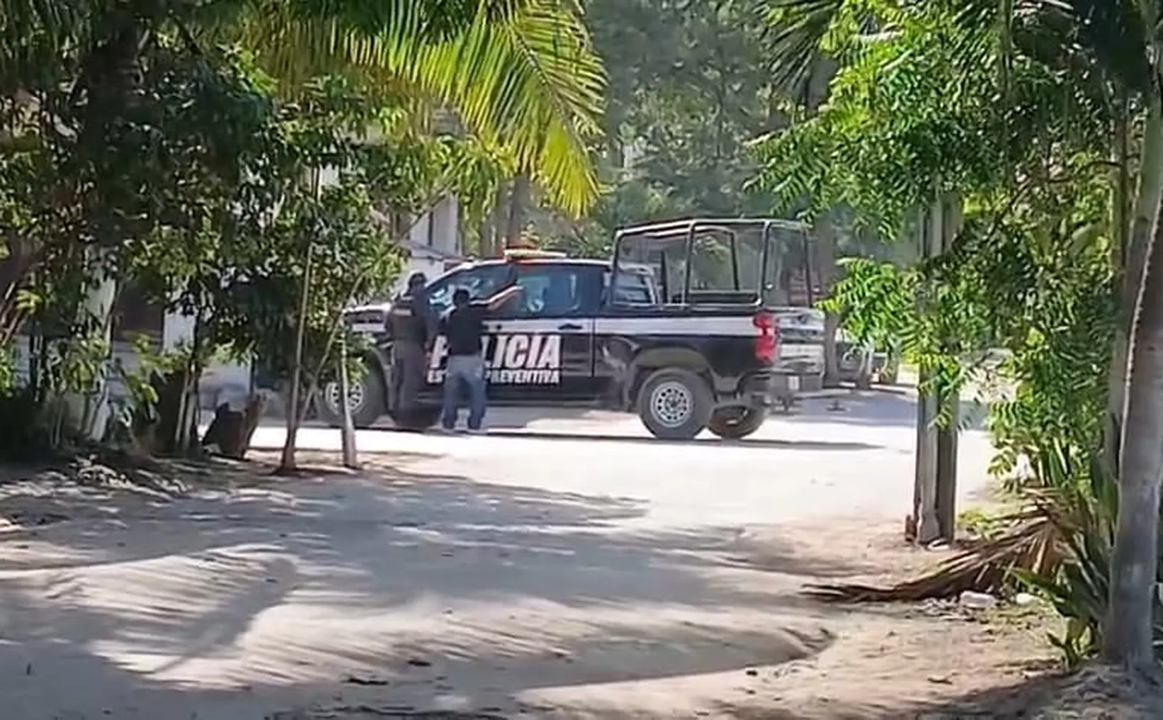 Police patrol car blocking street in Cancún neighborhood