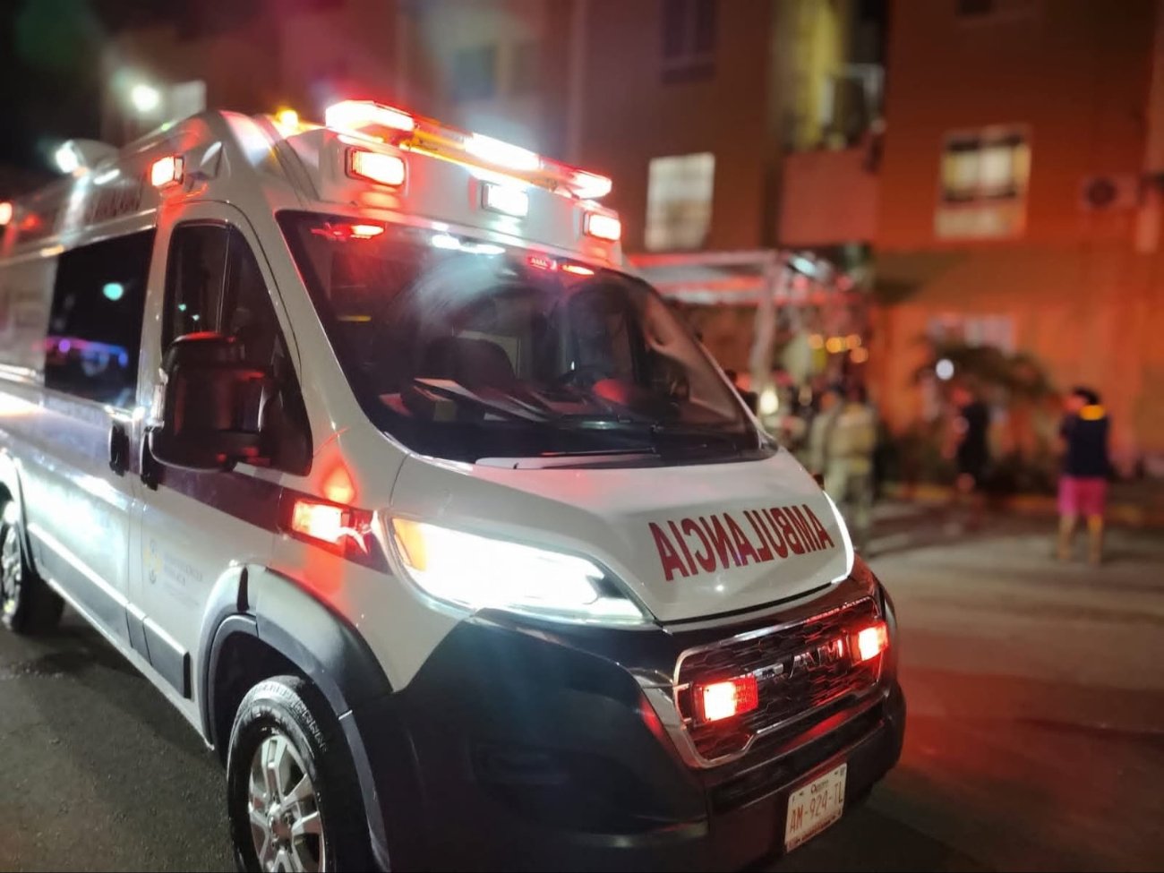 Emergency personnel transport a victim after a machete attack in Cancún