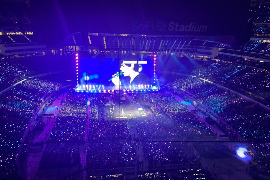 BTS performing on stage with 360-degree format at Estadio GNP Seguros in Mexico City