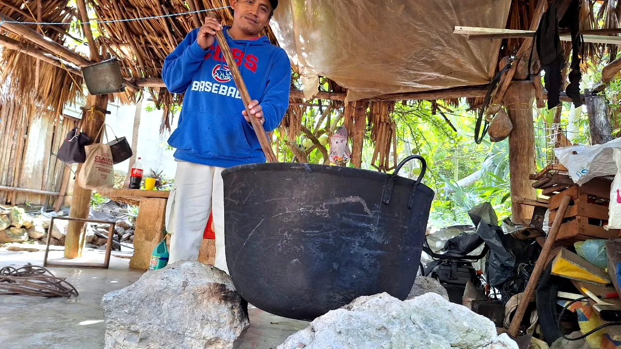 Chicle sap being cooked over fire to obtain natural chewing gum consistency