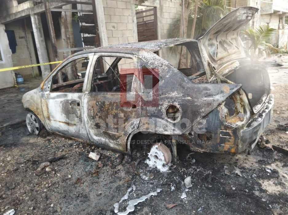 A vehicle engulfed in flames in the Inn House settlement of Playa del Carmen