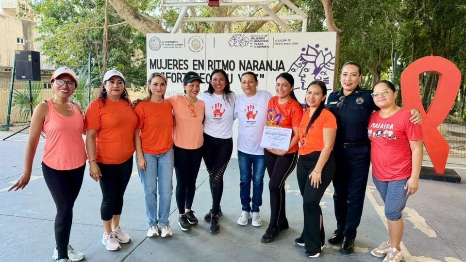 Women participating in Orange Day community activities in Puerto Aventuras