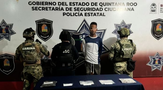 Police arresting a man with drug packets in Cancún