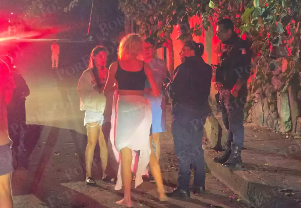 Paramedics providing medical attention to a woman on a street in Playa del Carmen