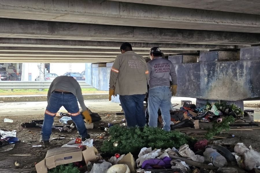 Municipal workers removing debris from under a bridge in Playa del Carmen