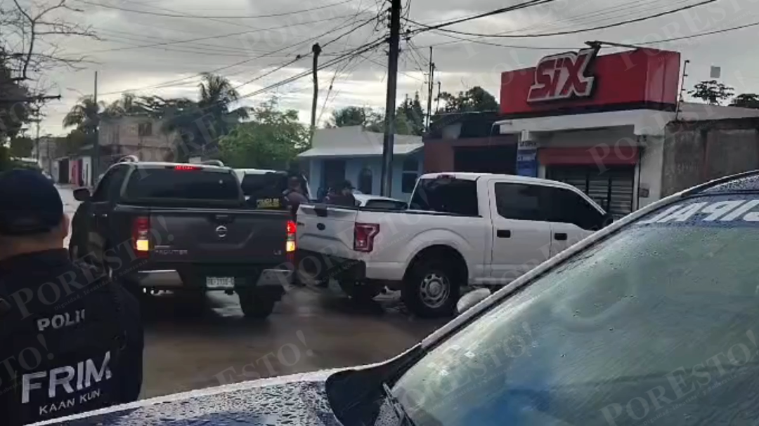 Police officers conducting a raid at a property in Cancún's Region 230