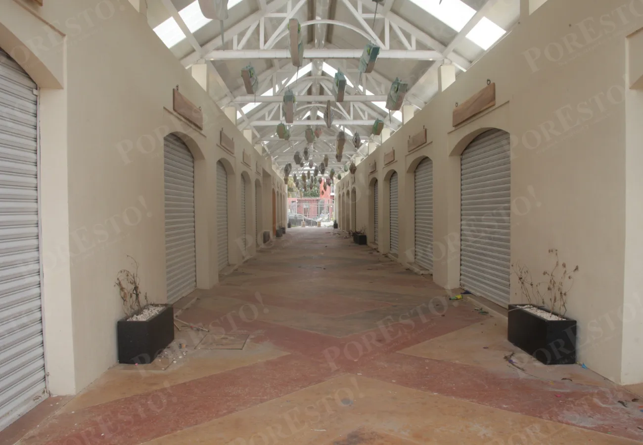 Merchants at Puerto Juárez market in Cancún showing promises of shop and restaurant openings that have not materialized