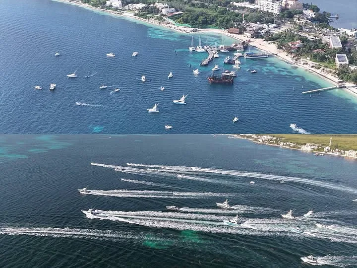Aerial view of a coastal area featuring multiple boats on the water, with a beach and dock in the background. The image is split, showing two different sections of water activity, with one side having a tranquil setting and the other with boats leaving wake trails.