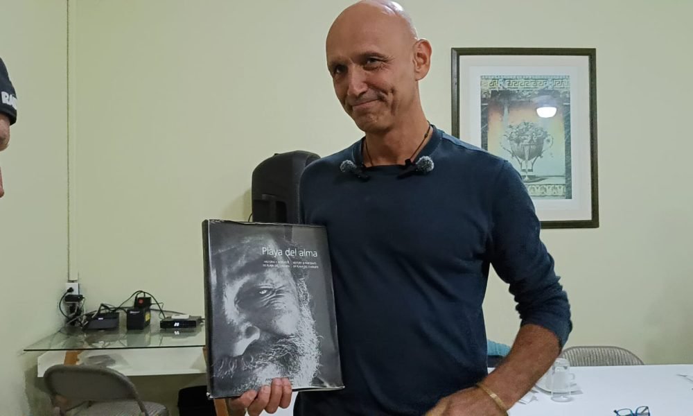 Italian photographer Anthony Caronia holding his book Playa del Alma