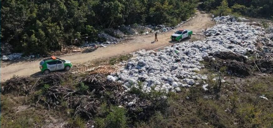 Authorities inspecting an illegal dump site near Cancún International Airport