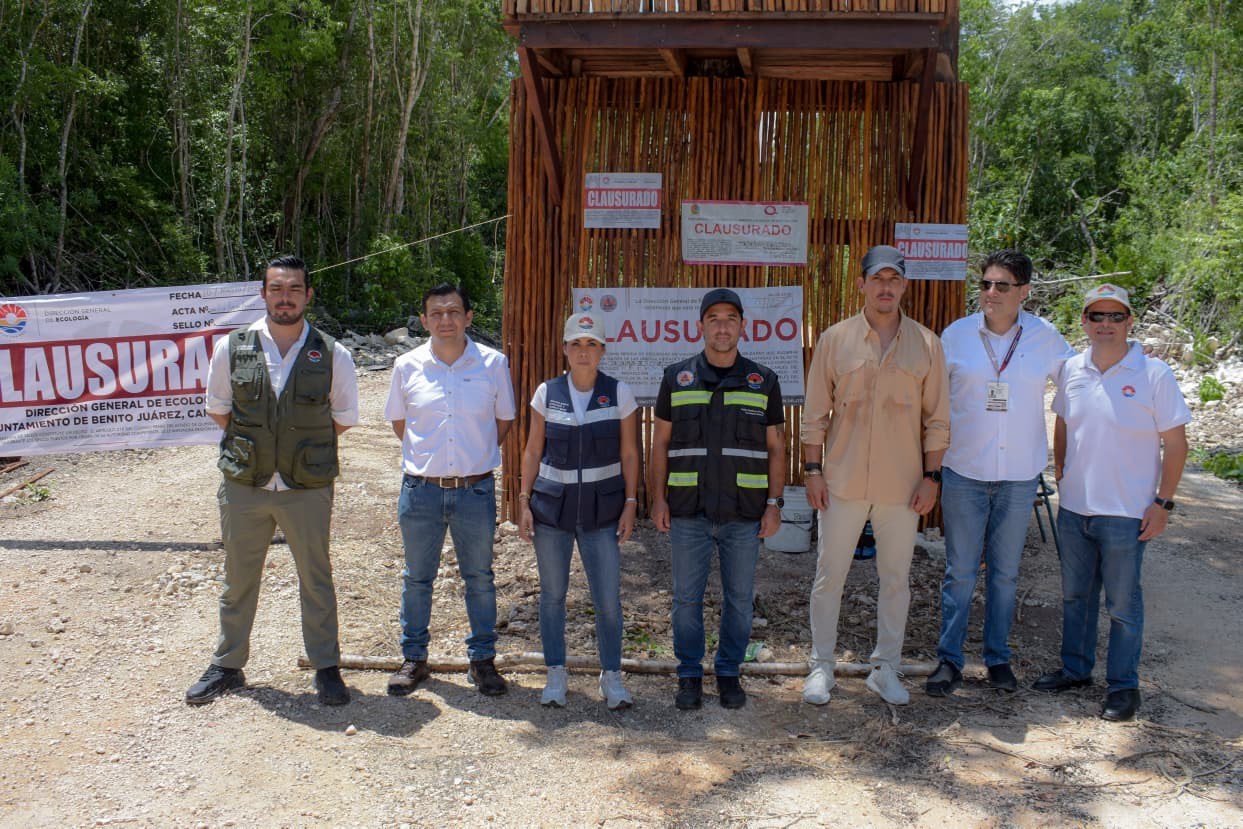 Officials inspecting a closed land development site in Cancún